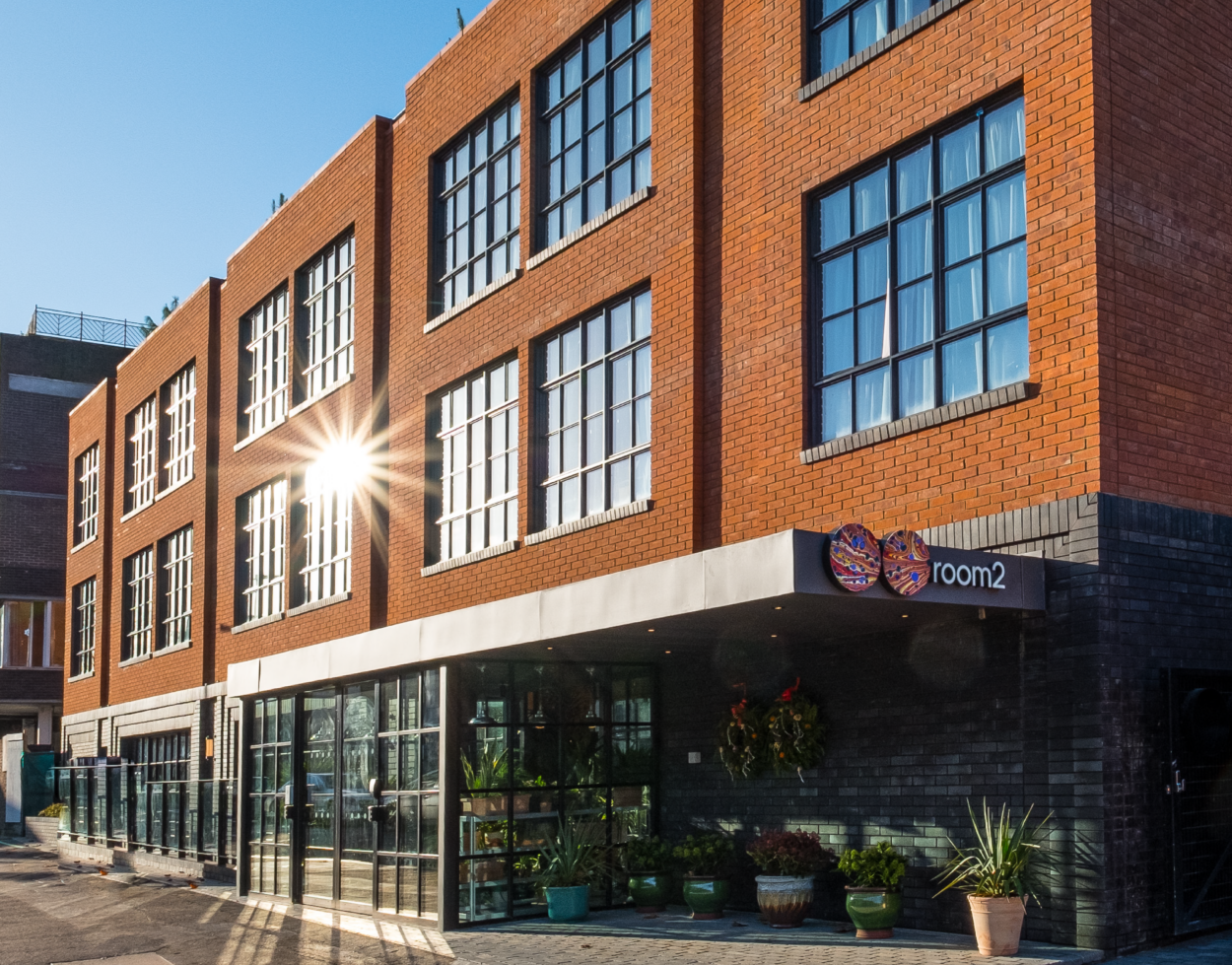 A large brick building with large windows and a glass door entrance.
